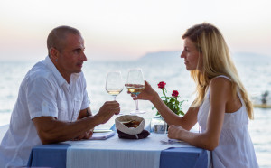 Couple in sea restaurant at sunset